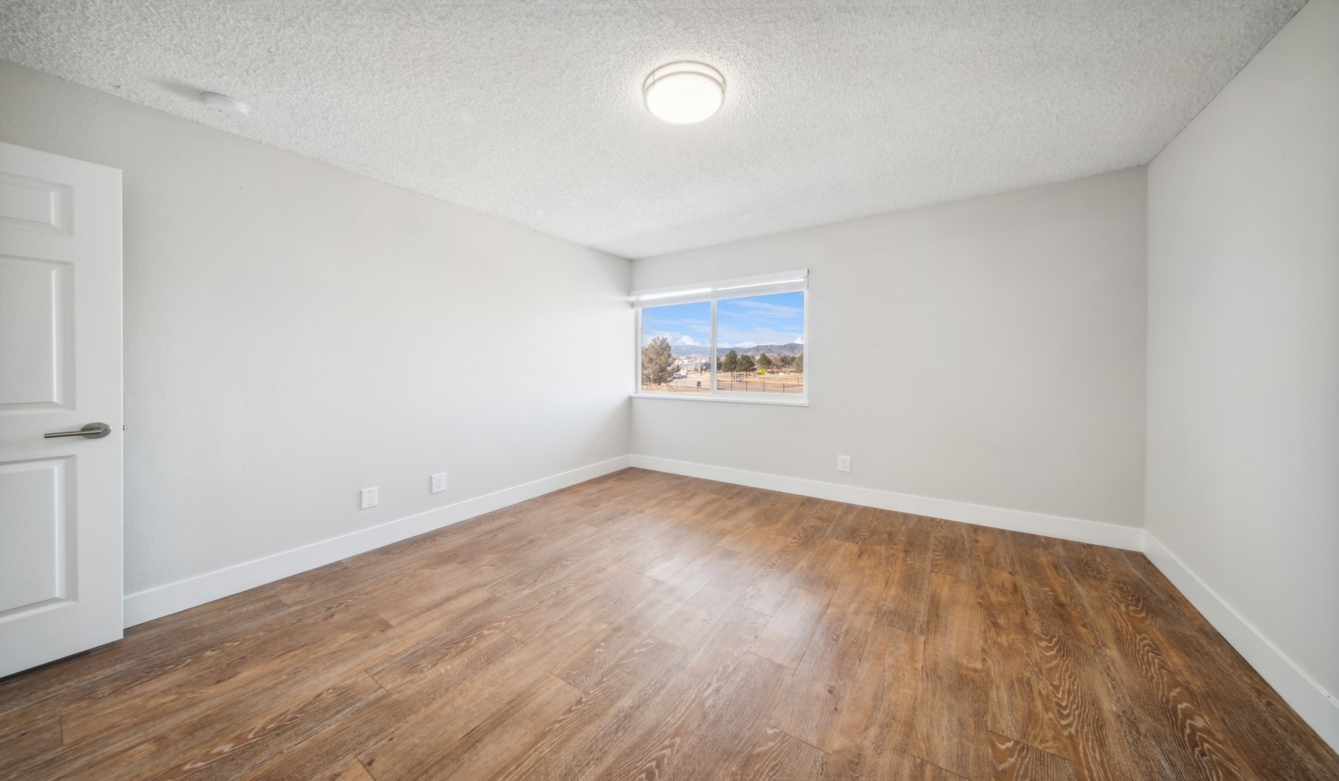 Large spacious bedrooms with wood flooring  